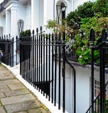 Stunning Georgian townhouses with classic ironwork in Kensington, London. Captured outdoors during the day.